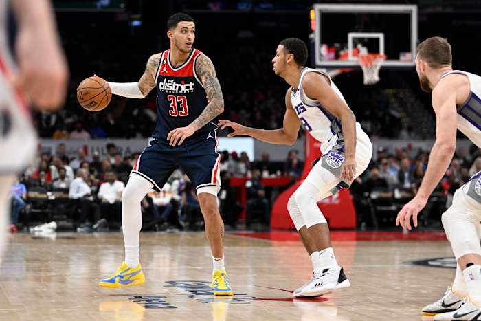 Washington Wizards forward Kyle Kuzma (33) dribbles as Sacramento Kings forward Keegan Murray (13) defends during the second half at Capital One Arena.